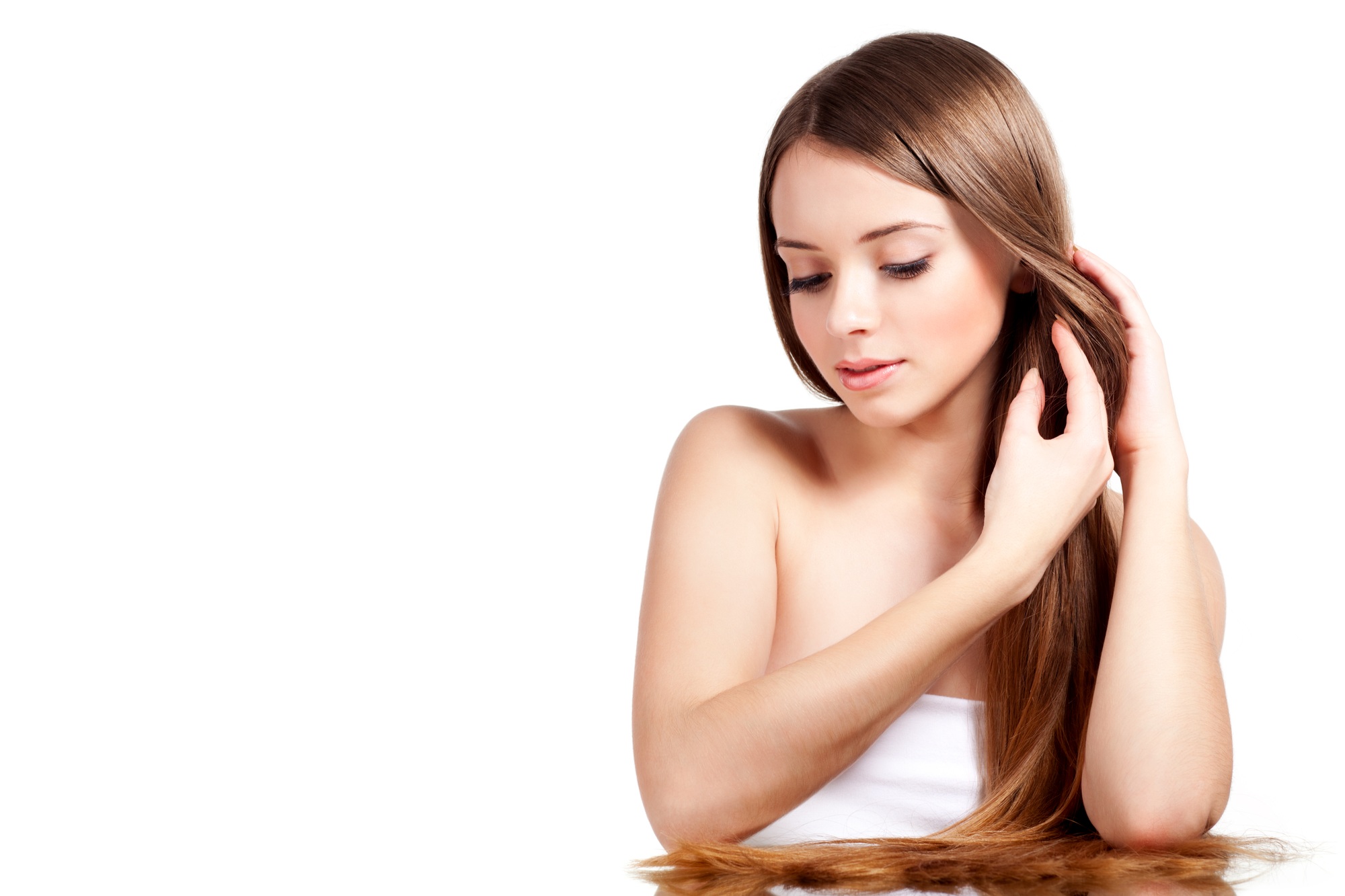 Woman straightens brown hair on white background
